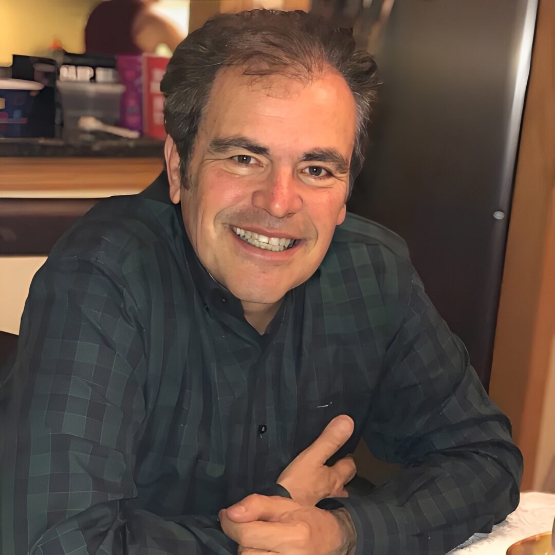 Smiling man sitting at a table